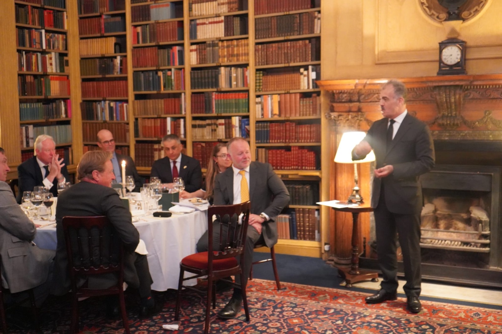 A speaker addresses guests during the launch dinner at the Travellers Club