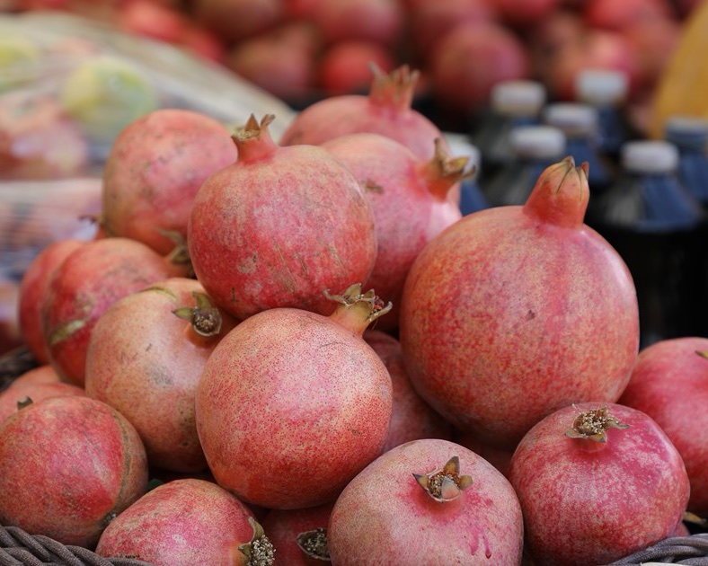 A basket of fresh Kurdish pomegranates at a market
